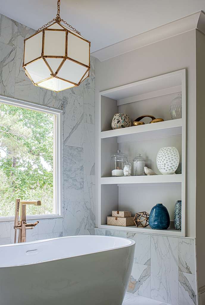 Atlanta’s Top Interior Designer Nesbit Ferry Road Residence Project Master Bath Tub, light fixture, and shelving detail image.